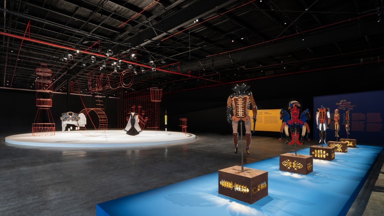After Rain, Diriyah Contemporary Art Biennale 2024, installation view Dhali Al Mamoon, Kather Nripati (Wooden Lord) (2021), front; Taus Makhacheva, Charivari  (2019), back.
